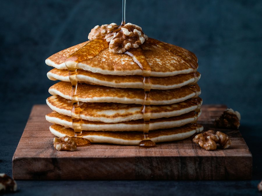 Stack of pancakes drizzled with syrup