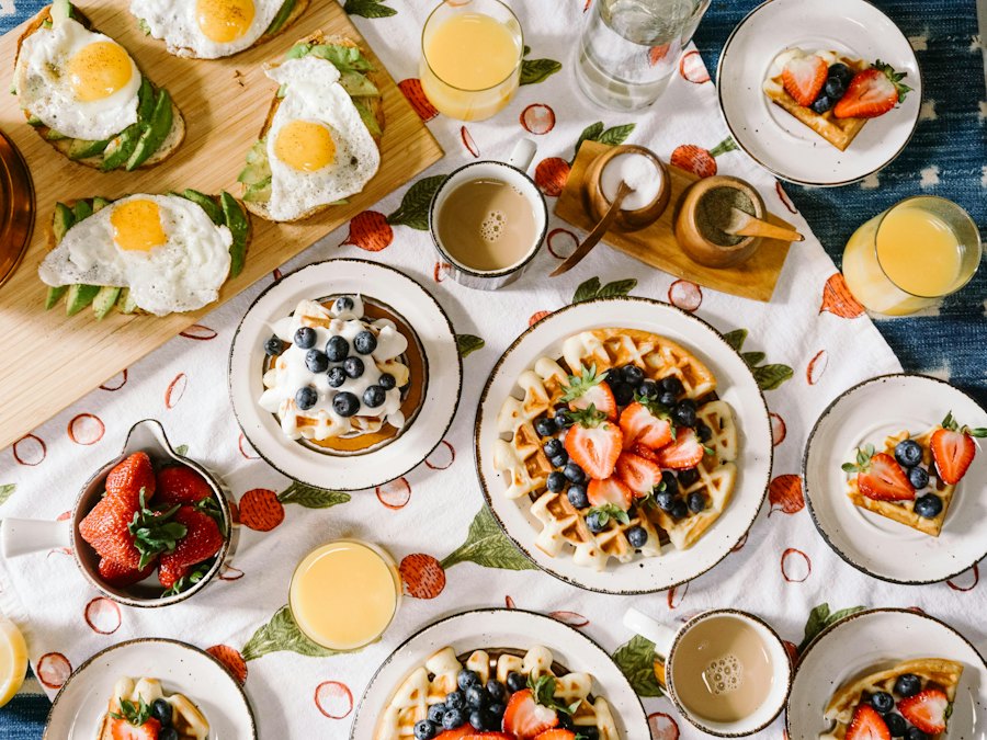 Brunch spread with waffles, eggs, avocado toast and juice