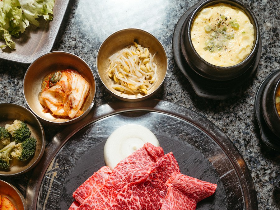 Korean barbecue table spread with grilled meats and side dishes