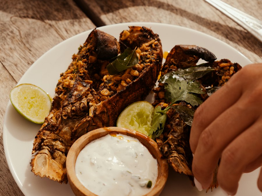Lobster tails with dipping sauce and lime wedges