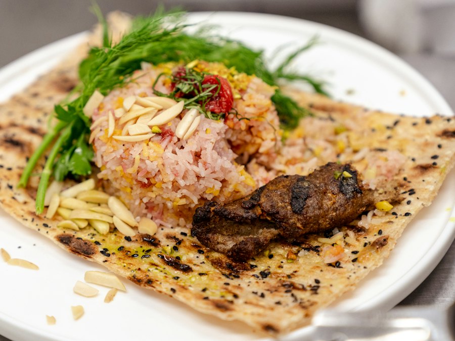 Persian kebab plate with rice and fresh herbs